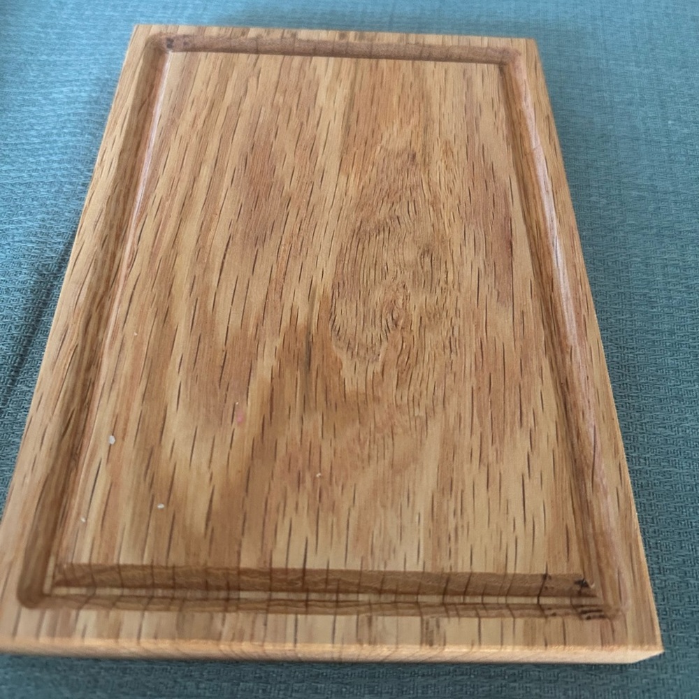 Small charcuterie board with juice grove around the edge